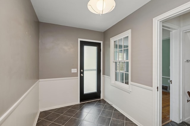 4150 Beard Ave N, Robbinsdale, MN 55422 - doorway to outside featuring dark tile patterned flooring and baseboards