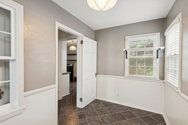 4150 Beard Ave N, Robbinsdale, MN 55422 - unfurnished dining area with dark tile patterned floors and baseboards