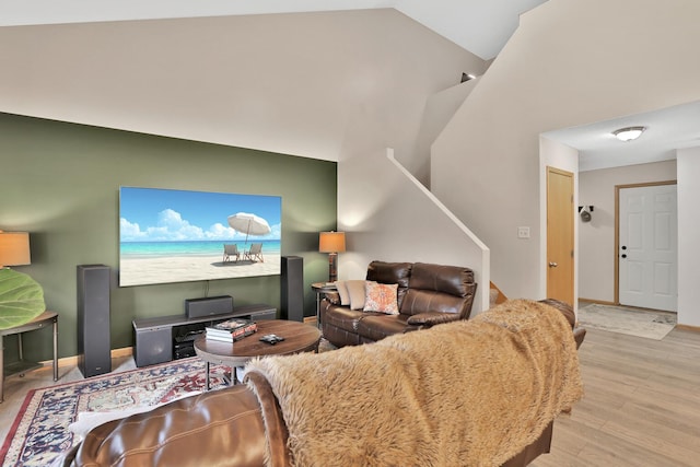 2171 Cleveland Way S, Cambridge, MN 55008 - living area featuring wood finished floors, baseboards, stairs, and high vaulted ceiling