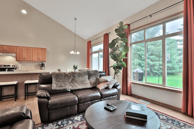 2171 Cleveland Way S, Cambridge, MN 55008 - living area featuring a chandelier, high vaulted ceiling, and light wood-style flooring