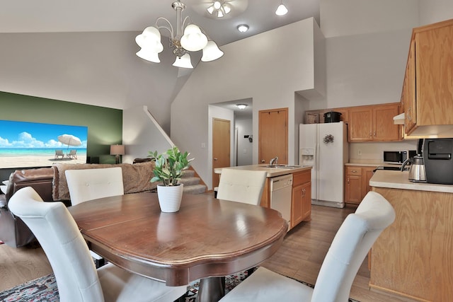 2171 Cleveland Way S, Cambridge, MN 55008 - dining room with a chandelier, wood finished floors, stairway, and high vaulted ceiling