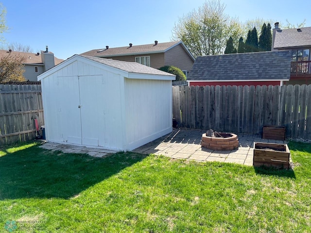 view of yard with an outdoor fire pit, a storage unit, a patio, and an outdoor structure