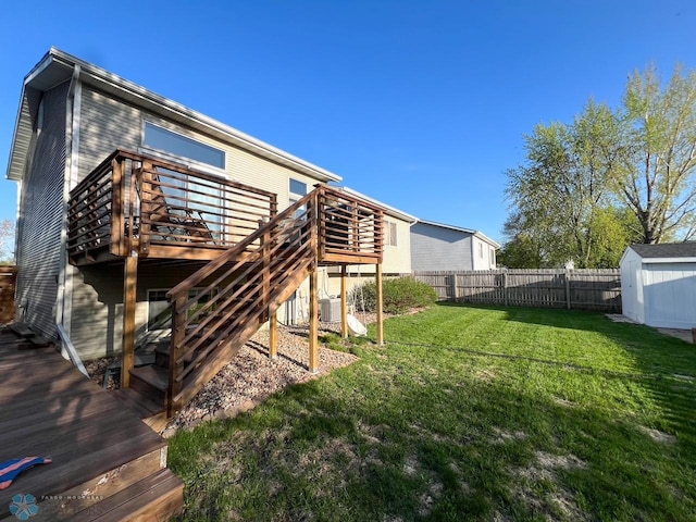 rear view of property with a deck, a shed, an outdoor structure, and stairway