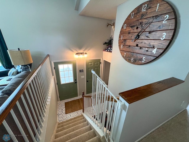 staircase with baseboards and carpet