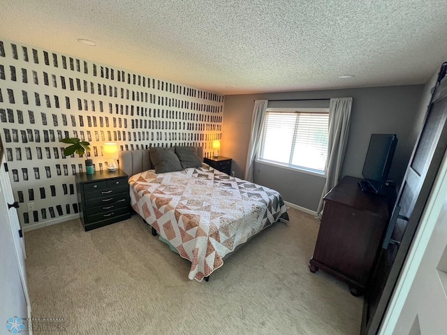 bedroom with a textured ceiling and light carpet