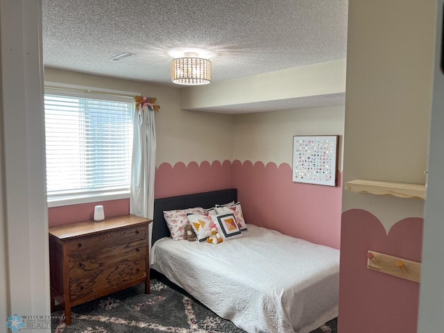 carpeted bedroom featuring a textured ceiling