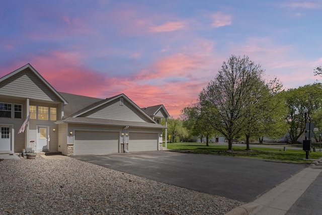5678 Sherman Oaks Rd, Stacy, MN 55079 - view of front of house featuring driveway, an attached garage, and stone siding