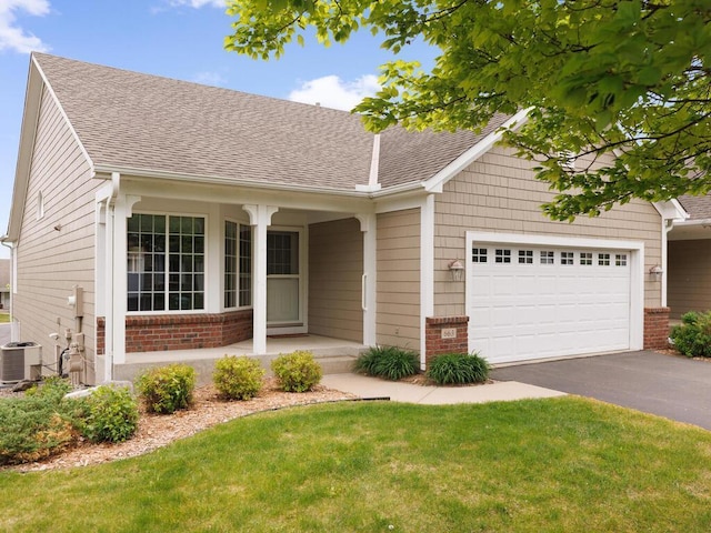 663 Regent Ln, Waconia, MN 55387 - single story home featuring brick siding, a garage, driveway, cooling unit, and roof with shingles