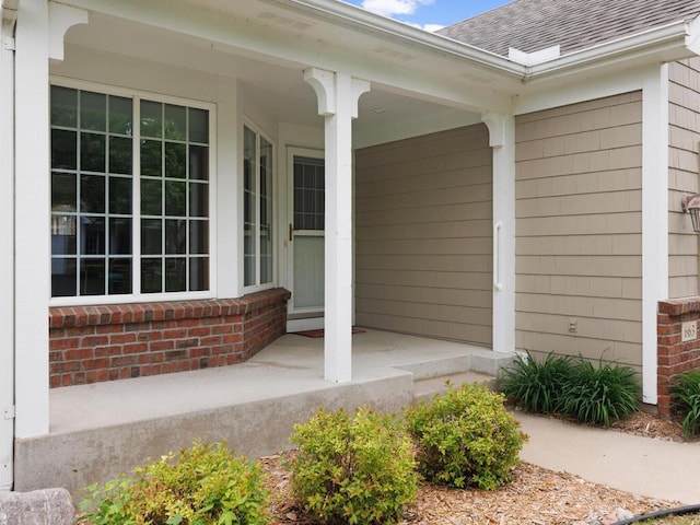 663 Regent Ln, Waconia, MN 55387 - entrance to property with covered porch, roof with shingles, and brick siding