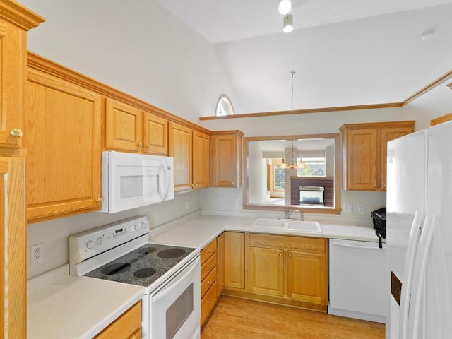 663 Regent Ln, Waconia, MN 55387 - kitchen with white appliances, a sink, a chandelier, light countertops, and high vaulted ceiling