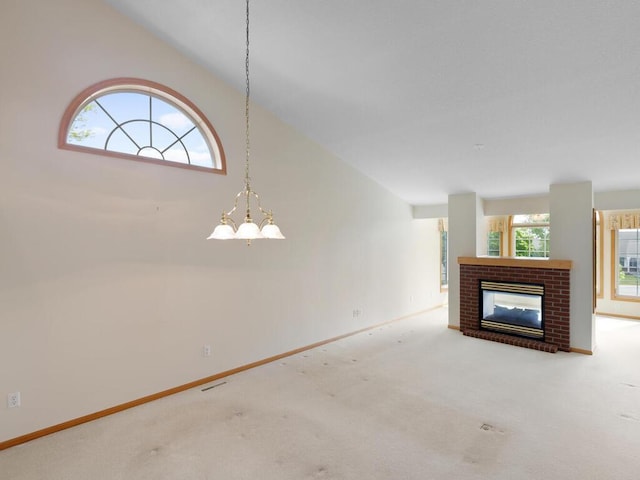 663 Regent Ln, Waconia, MN 55387 - unfurnished living room with vaulted ceiling, carpet flooring, a brick fireplace, and baseboards