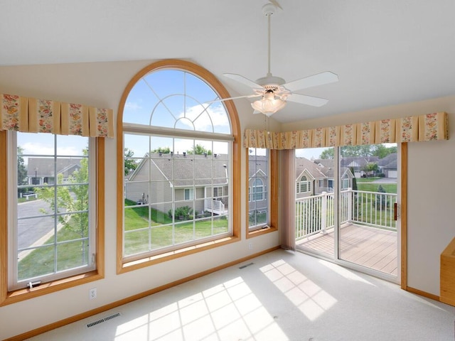 663 Regent Ln, Waconia, MN 55387 - unfurnished sunroom featuring vaulted ceiling and a residential view