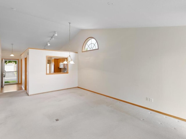 663 Regent Ln, Waconia, MN 55387 - carpeted spare room with vaulted ceiling, plenty of natural light, baseboards, and track lighting