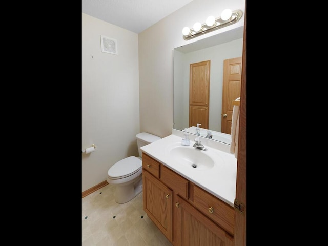 663 Regent Ln, Waconia, MN 55387 - bathroom with toilet, vanity, baseboards, and tile patterned floors