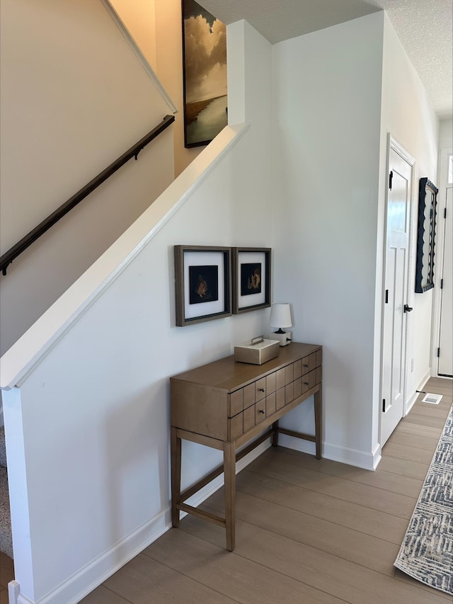 14536 74th St NE, Otsego, MN 55330 - corridor featuring baseboards, wood finished floors, and stairway
