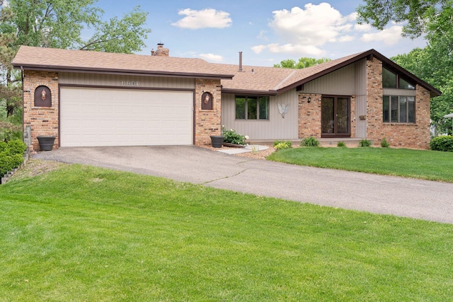 3291 Hillsboro Ave S, Saint Louis Park, MN 55426 - view of front of property featuring a chimney, driveway, brick siding, a garage, and a front yard