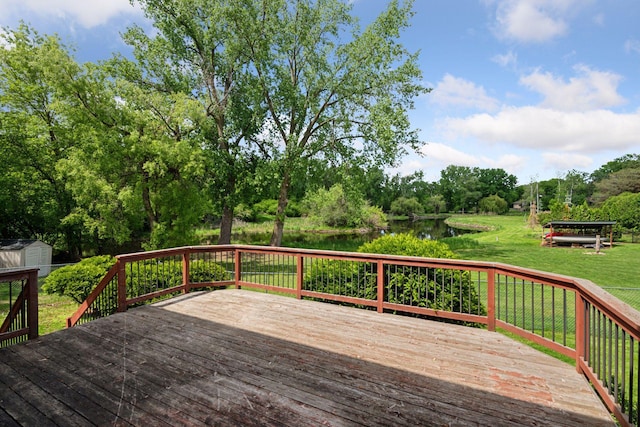 3291 Hillsboro Ave S, Saint Louis Park, MN 55426 - wooden terrace featuring a water view, a lawn, a storage shed, and view of wooded area