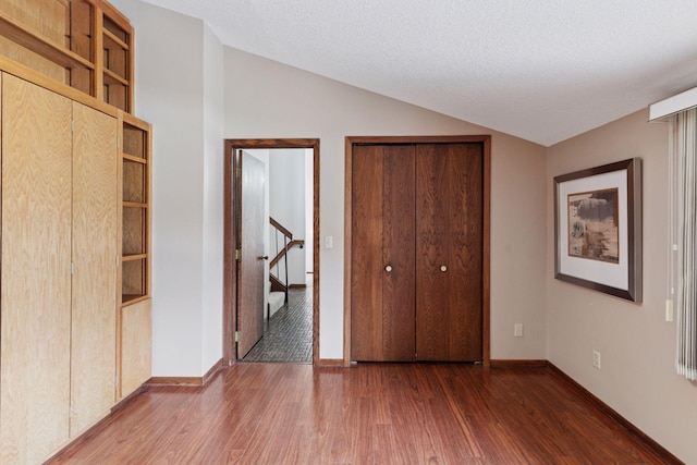 3291 Hillsboro Ave S, Saint Louis Park, MN 55426 - unfurnished bedroom featuring wood finished floors and vaulted ceiling