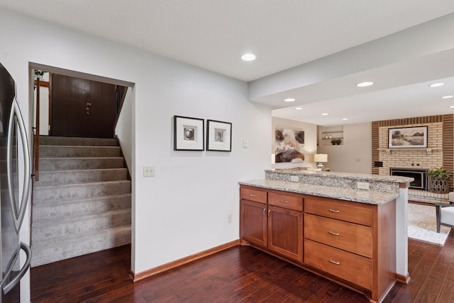 3291 Hillsboro Ave S, Saint Louis Park, MN 55426 - kitchen with freestanding refrigerator, a peninsula, brown cabinetry, dark wood-style floors, and recessed lighting