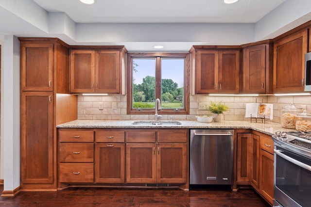 3291 Hillsboro Ave S, Saint Louis Park, MN 55426 - kitchen featuring stainless steel appliances, light stone countertops, dark wood finished floors, recessed lighting, and backsplash