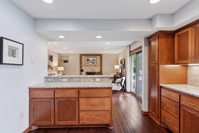 3291 Hillsboro Ave S, Saint Louis Park, MN 55426 - kitchen with a peninsula, brown cabinets, dark wood finished floors, light stone counters, and recessed lighting