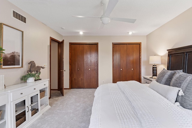3291 Hillsboro Ave S, Saint Louis Park, MN 55426 - bedroom featuring light colored carpet, two closets, and a ceiling fan