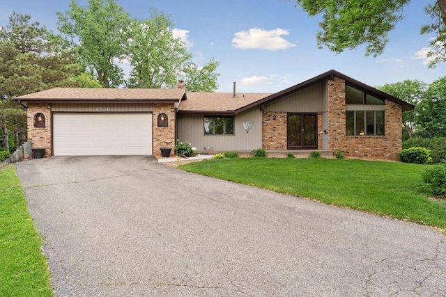 3291 Hillsboro Ave S, Saint Louis Park, MN 55426 - view of front of home with brick siding, a garage, and concrete driveway