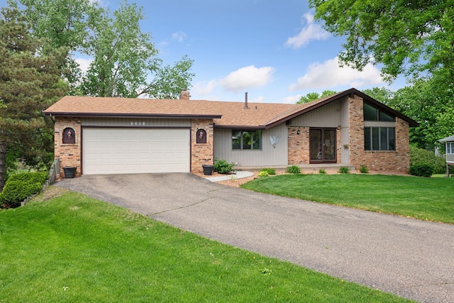 3291 Hillsboro Ave S, Saint Louis Park, MN 55426 - view of front of house featuring driveway, a garage, a chimney, brick siding, and a front yard