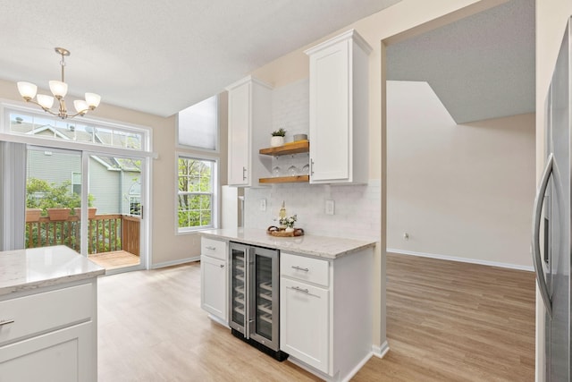 1353 White Oak Dr, Chaska, MN 55318 - kitchen with wine cooler, light wood-style flooring, open shelves, and freestanding refrigerator