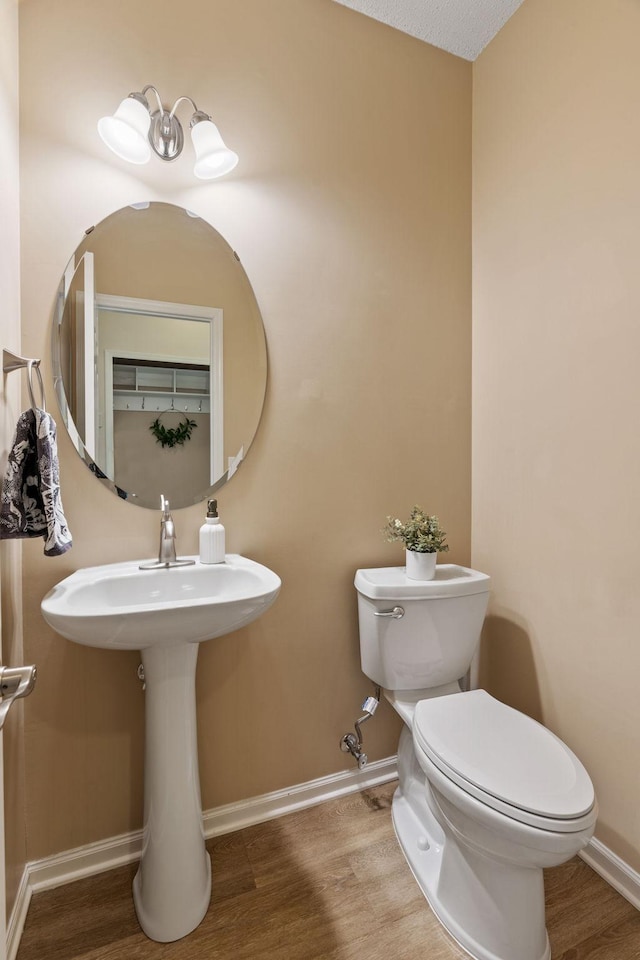 1353 White Oak Dr, Chaska, MN 55318 - bathroom with wood finished floors, toilet, and baseboards