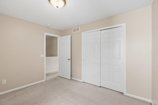 1353 White Oak Dr, Chaska, MN 55318 - unfurnished bedroom with light colored carpet, baseboards, a closet, and a textured ceiling