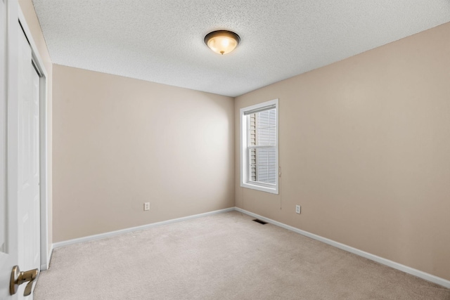 1353 White Oak Dr, Chaska, MN 55318 - unfurnished bedroom featuring light colored carpet, a textured ceiling, a closet, and baseboards