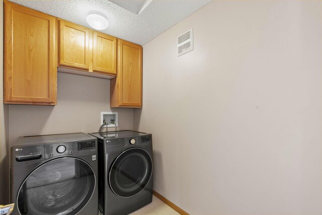 1353 White Oak Dr, Chaska, MN 55318 - laundry area featuring cabinet space, washer and dryer, baseboards, and a textured ceiling