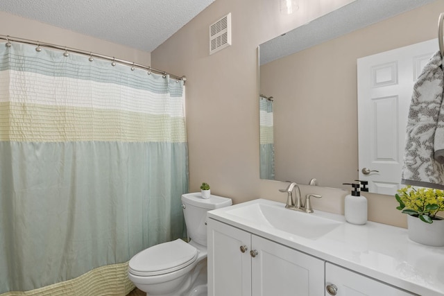1353 White Oak Dr, Chaska, MN 55318 - bathroom featuring a textured ceiling, toilet, and vanity