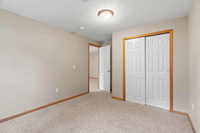 1353 White Oak Dr, Chaska, MN 55318 - unfurnished bedroom featuring carpet, baseboards, a closet, and a textured ceiling