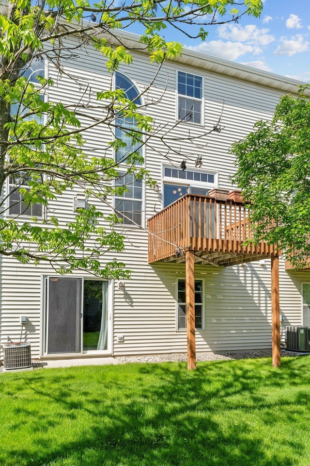 1353 White Oak Dr, Chaska, MN 55318 - back of property with a lawn, central air condition unit, and a wooden deck
