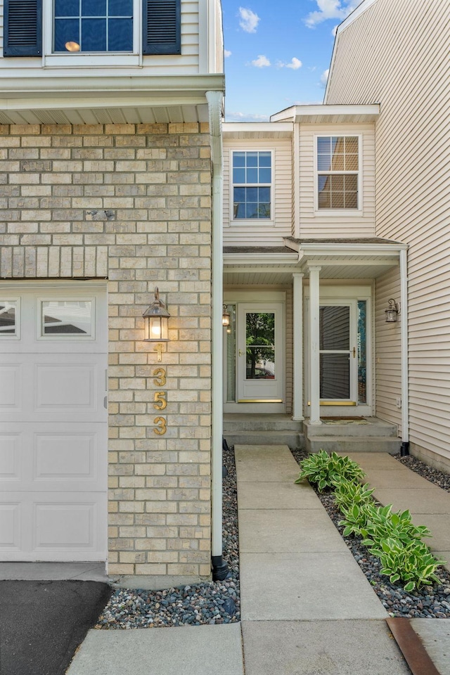 1353 White Oak Dr, Chaska, MN 55318 - property entrance featuring a garage and brick siding