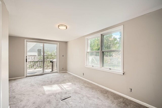 6670 Hopi Rd, Chanhassen, MN 55317 - carpeted spare room featuring healthy amount of natural light and baseboards