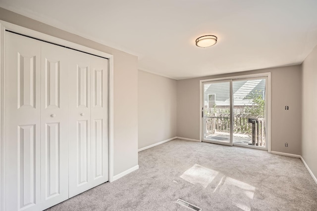 6670 Hopi Rd, Chanhassen, MN 55317 - unfurnished bedroom with access to exterior, carpet flooring, baseboards, and a closet