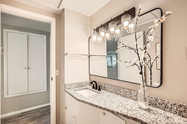 6670 Hopi Rd, Chanhassen, MN 55317 - bathroom with wood finished floors, vanity, and baseboards