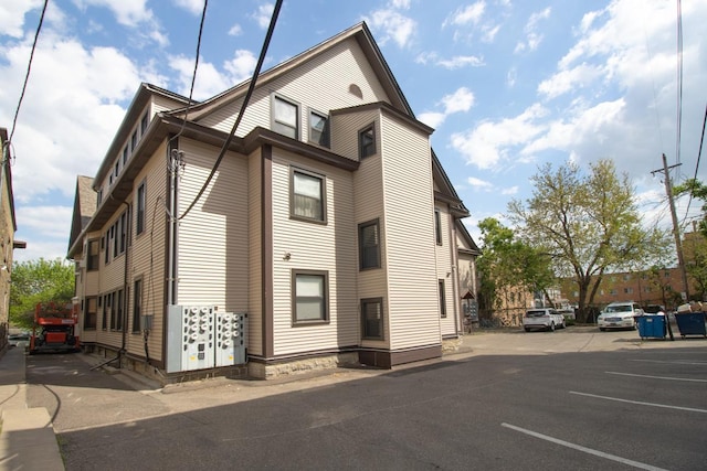 view of property exterior featuring uncovered parking
