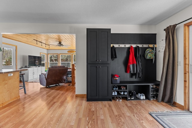 mudroom with light wood finished floors, a ceiling fan, and baseboards
