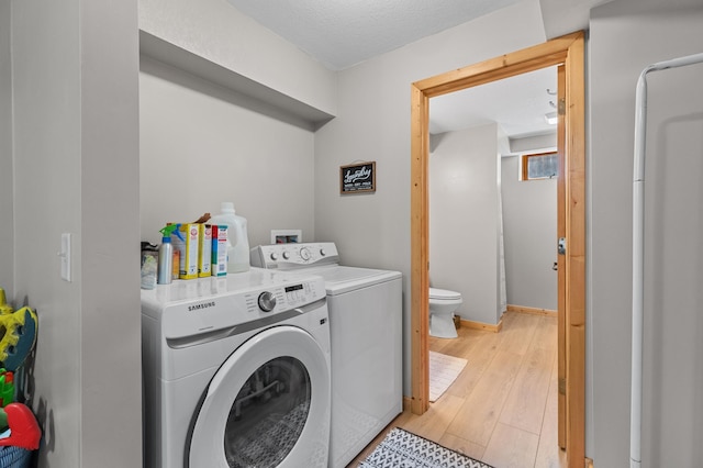30432 Pinewood Dr, Breezy Point, MN 56472 - laundry room featuring washing machine and dryer and light wood finished floors