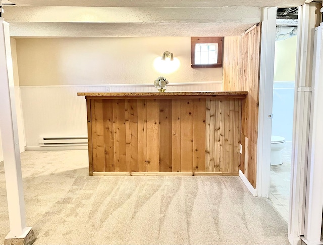 bar area with carpet, a baseboard heating unit, and wooden walls