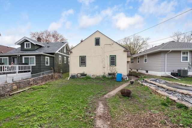 back of property with central AC and stucco siding