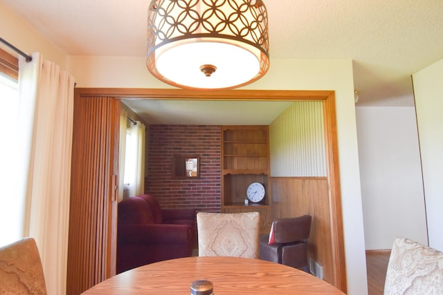13946 151st St NE, Thief River Falls, MN 56701 - dining space featuring healthy amount of natural light, wood finished floors, a textured ceiling, and built in shelves