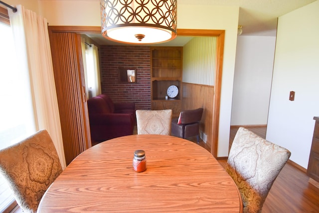 13946 151st St NE, Thief River Falls, MN 56701 - dining area featuring wood finished floors, plenty of natural light, baseboards, and built in features