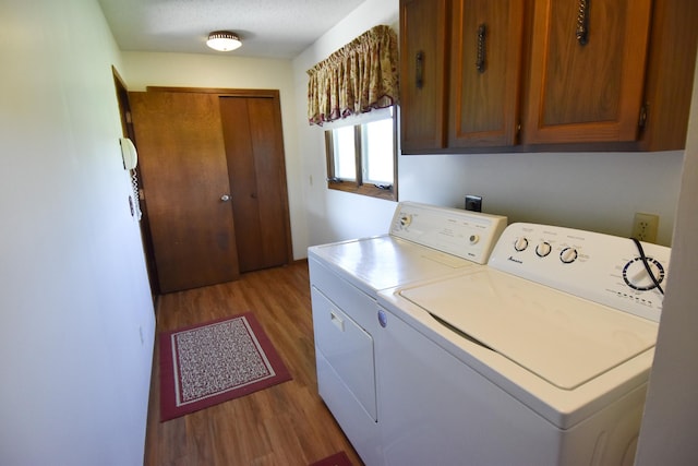 13946 151st St NE, Thief River Falls, MN 56701 - laundry area with wood finished floors, washing machine and clothes dryer, and cabinet space