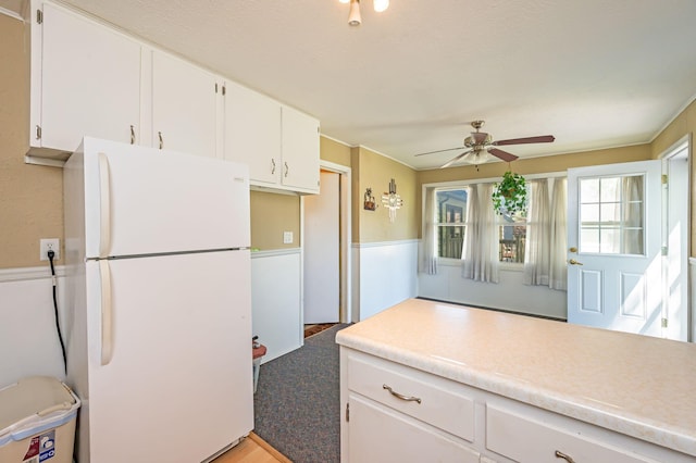 1202 Webster St, Fairmont, MN 56031 - kitchen featuring freestanding refrigerator, ceiling fan, white cabinetry, and light countertops
