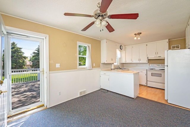 1202 Webster St, Fairmont, MN 56031 - kitchen with white appliances, under cabinet range hood, white cabinets, a peninsula, and a textured ceiling